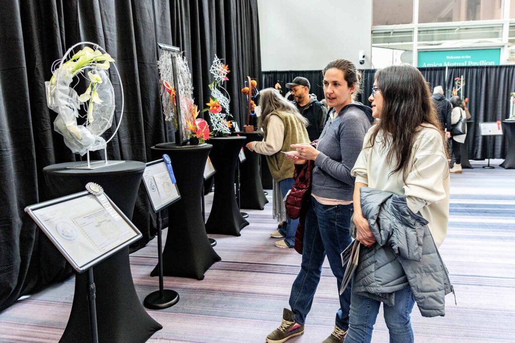 RI Specialty Flower Show | Woman at RI Home Show looking at floral displays | Annual Rhode Island Home Show